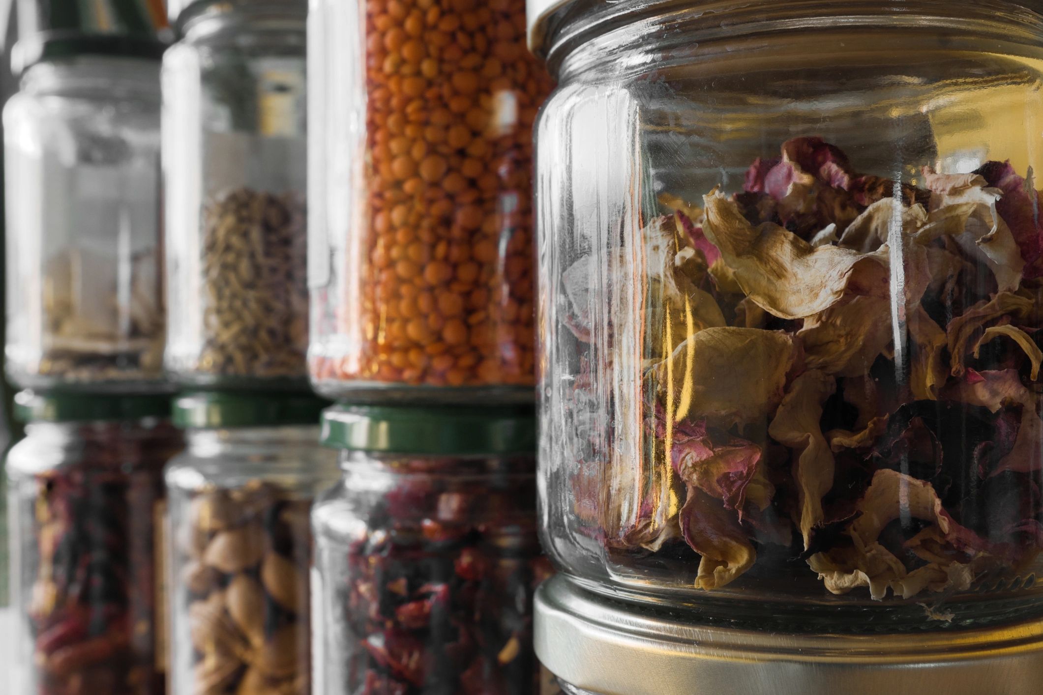 Herbs and spices arranged in glass containers